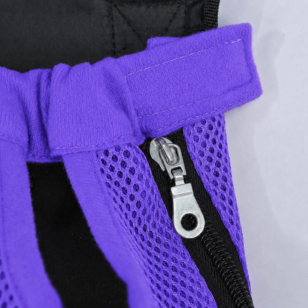 Gros plan sur la fermeture éclair latérale et la patte auto-agrippante du sac L'Éclaireur violet, en maille respirante violette